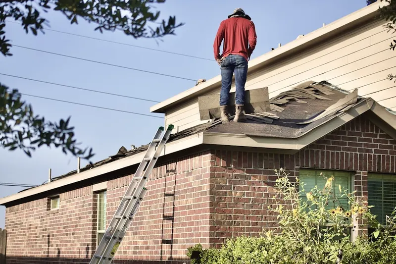 Professional roofer working on a residential roof in Metropolis View